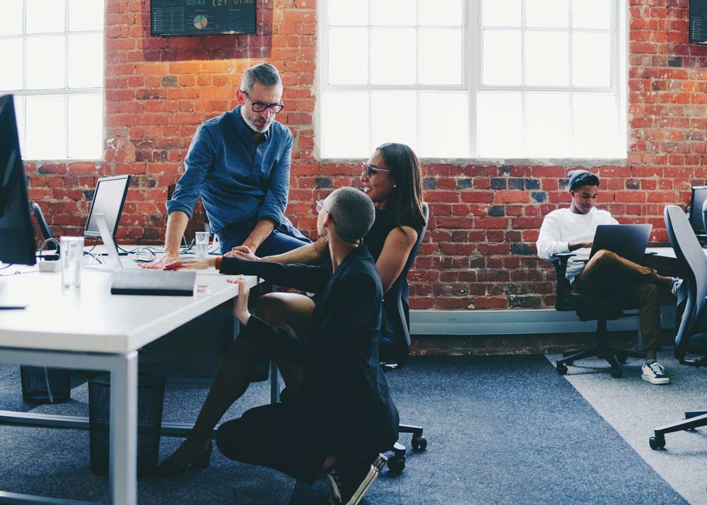 group of people in their office talking