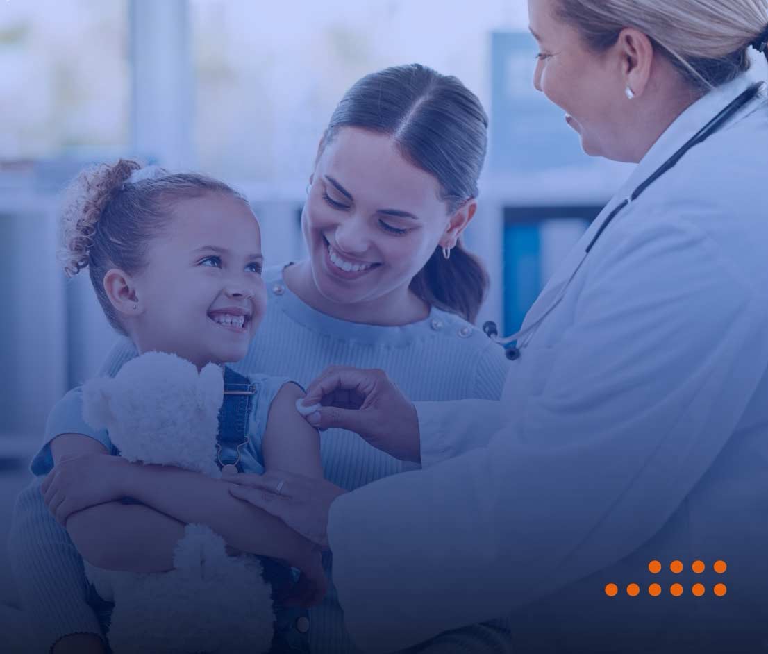 doctor treating child patient being held by caregiver