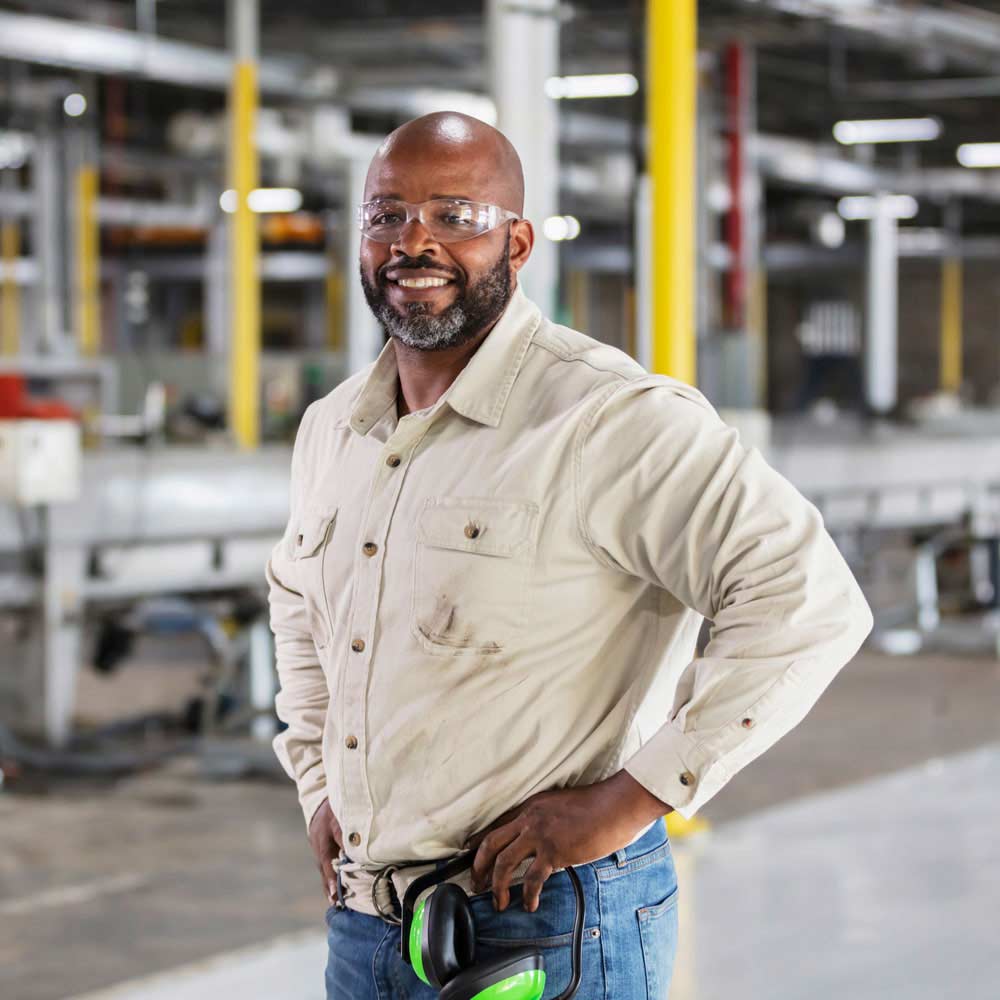 gentleman smiling at the camera inside a warehouse